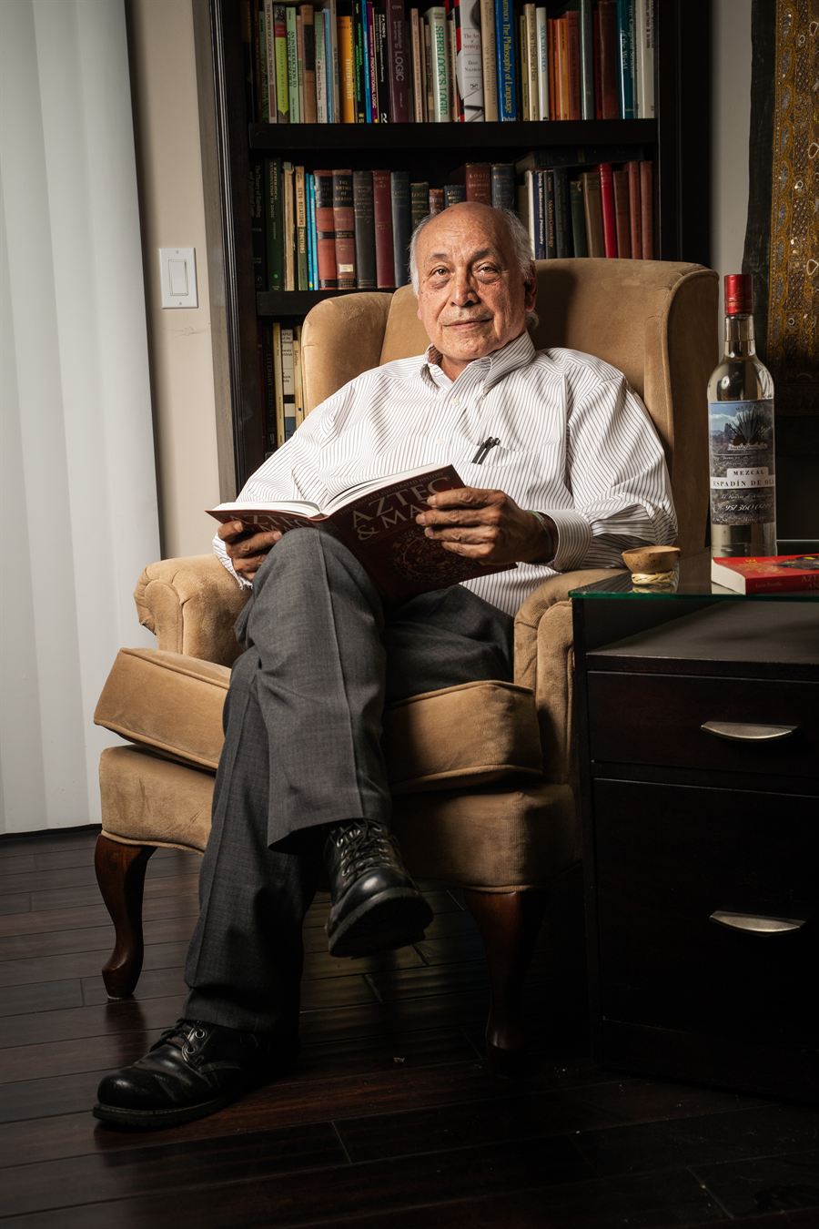 Dr. Alejandro Paz, President of Foundation Mixtecos Unidos, reading in his library