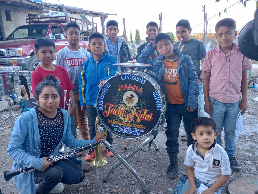Children of the Foundation Mixtecos Unidos School of Music, Banda Tachi Ndai, with their band drum in San Andrés Yutatío, Oaxaca