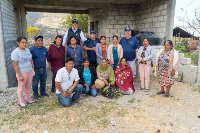 Artisanos line up to take a picture with the foundation