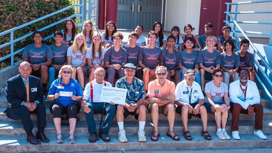 Rancho Buena Vista High cross-country team receiving a Foundation Mixtecos Unidos donation check