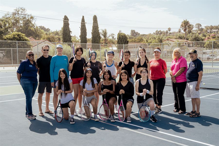 Vista High School girls tennis team on the court with Foundation Mixtecos Unidos supporters